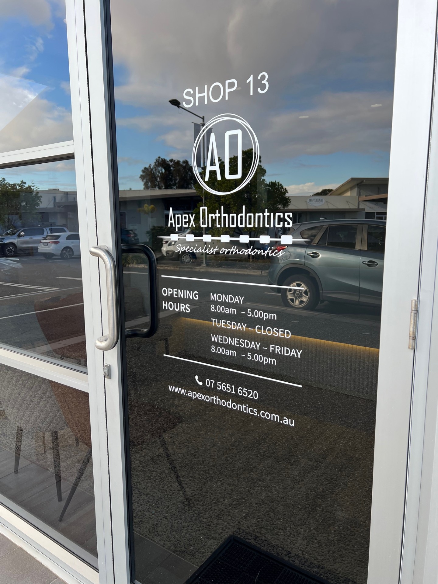 Young man with patient bib on a dental chair